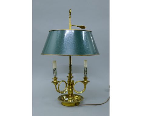A three light brass lamp with toleware shades. 54 cm high.