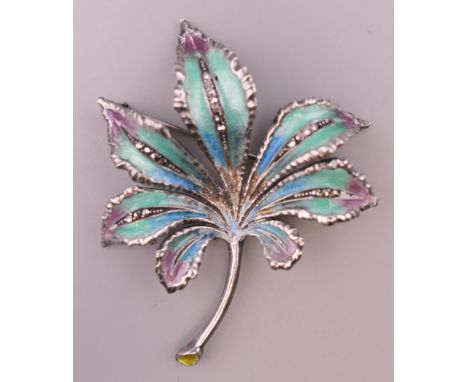 A silver enamel leaf form brooch.  6 cm high. 