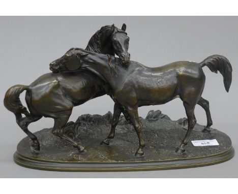 A bronze model of two horses, signed P J Mene. 33 cm long.