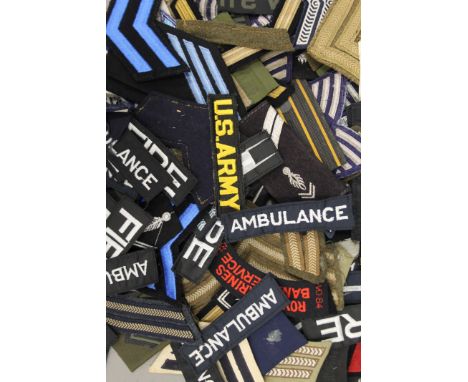 A collection of cloth patches, some military, including US Army and Police.
