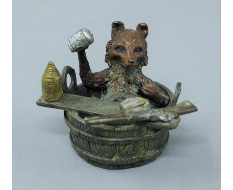 A cold painted bronze model of a fox in a bath. 5.5 cm high.