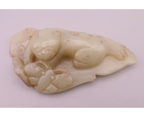 A jade model of a dog-of-fo and butterfly on a leaf.  11 cm long. 