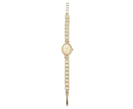 A 9 CARAT GOLD ROTARY BRACELET WATCH the oval champagne dial signed Rotary Elite with gilt batons and sword hands, oval case 