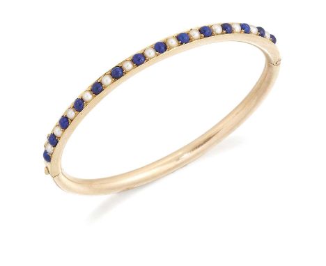 A LATE 19TH CENTURY LAPIS LAZULI AND SPLIT PEARL HINGE OPENING BANGLE alternating round lapis lazuli alternating with split p