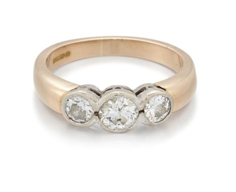 AN 18 CARAT GOLD OLD-CUT DIAMOND THREE STONE RING graduated old-cut diamonds in bezel settings. Estimated total diamond weigh