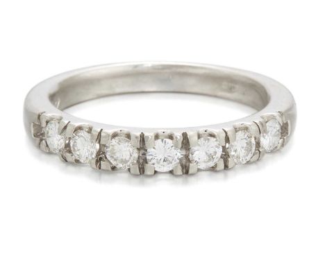 A PLATINUM DIAMOND HALF-HOOP RING round brilliant-cut diamonds in tension settings. Estimated total diamond weight 0.55ct, ha