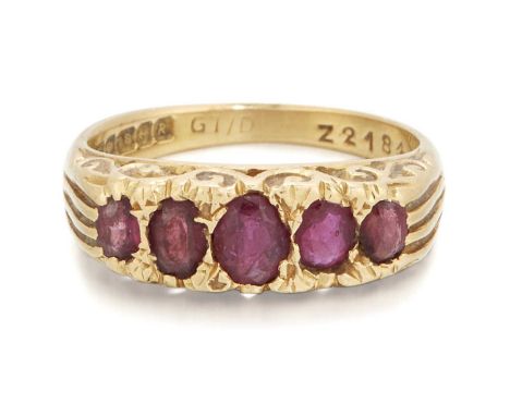 AN 18 CARAT GOLD RUBY RING five graduated oval-cut rubies in a carved setting. Hallmarked Birmingham 1991, ring size N, 6.3 g