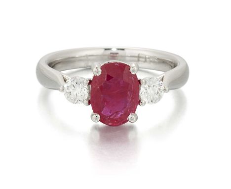 A PLATINUM RUBY AND DIAMOND THREE STONE RING an oval-cut ruby between round brilliant-cut diamonds. Estimated total diamond w