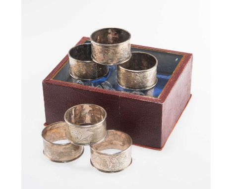 A SET OF SIX CHINESE EXPORT SILVER NAPKIN RINGS early 20th Century, unmarked, circular, each engraved with a dragon and carto