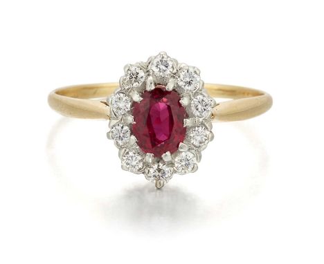 A RUBY AND DIAMOND CLUSTER RING an oval-cut ruby within a border of round brilliant-cut diamonds. Estimated total diamond wei