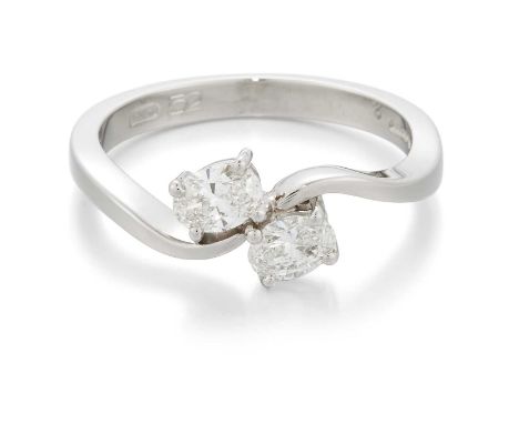 A PLATINUM OVAL-CUT DIAMOND TWO STONE CROSSOVER RING oval brilliant-cut diamonds in claw settings, to bypass scroll shoulders