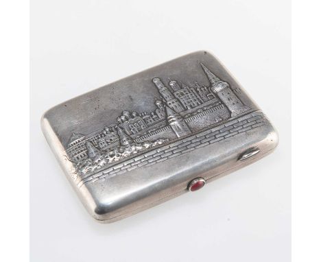 A RUSSIAN SILVER CIGARETTE CASE rectangular, embossed with a view of a city on the cover, red 'stone' inset push-button, engr