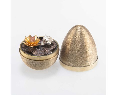 STUART DEVLIN: AN ELIZABETH II SILVER-GILT SURPRISE EGG by Stuart Devlin, London 1971, opening to reveal a frog sitting on li