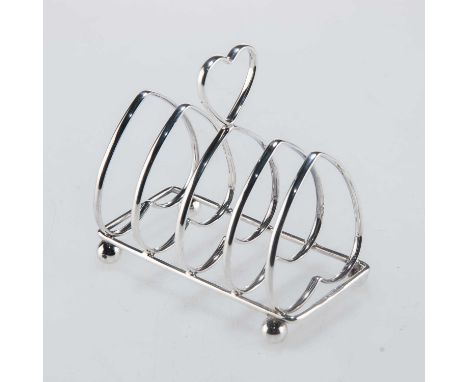 AN EDWARDIAN SILVER TOAST RACK by George Howson, Sheffield 1902, of five-bar design, the bars and loop handle heart-shaped, o