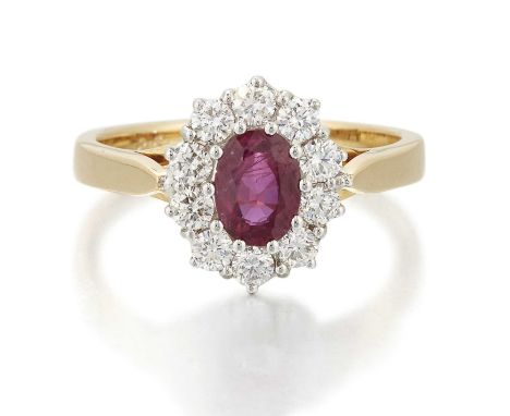 AN 18 CARAT GOLD RUBY AND DIAMOND CLUSTER RING an oval-cut ruby within a border of round brilliant-cut diamonds. Estimated to