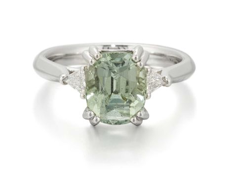 A PLATINUM GREEN TOURMALINE AND DIAMOND THREE STONE RING a cushion-cut green tourmaline between trilliant-cut diamonds. Estim