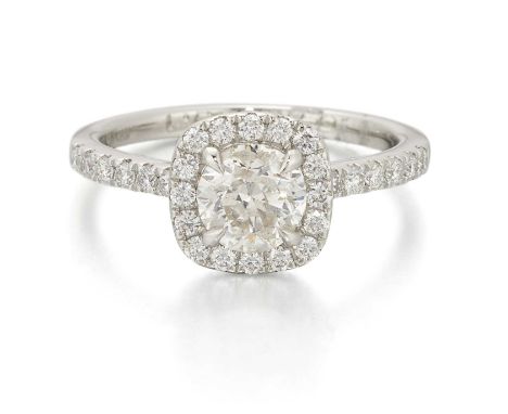 A PLATINUM DIAMOND CLUSTER RING a round brilliant-cut diamond within a cushion-shaped border of round brilliant-cut diamonds,