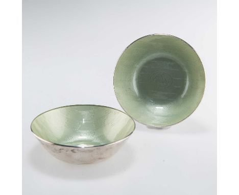 A PAIR OF NORWEGIAN SILVER AND ENAMEL BOWLS by J. Tostrup, each decorated with green enamel and with the image of a Viking bo