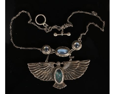 An Arts &amp; Crafts silver necklet formed as a stylized eagle. Set with an opal and three moonstones. Pendant 6.25cm wide. O