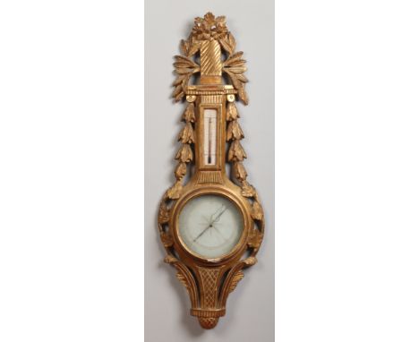 A French Louis XVI giltwood and gesso mercury wall barometer. With thermometer, inked dials and ornamented with husk festoons
