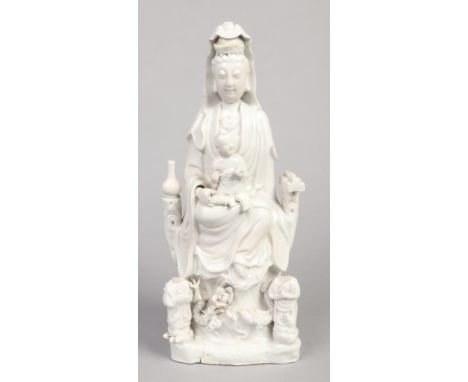 An 18th century Chinese blanc de chine statue of Guanyin and acolytes. Surrounded by precious objects, seated upon a throne o