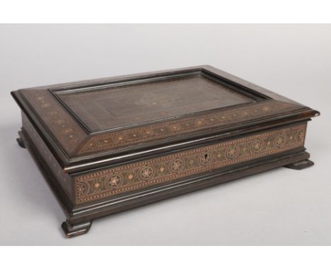 A 19th century Anglo-Indian table box. With mixed metal strung inlay and raised on bracket feet, 42.5cm wide. 