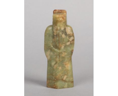 A 19th century Chinese jade sculpture. Carved in the form of a scholar wearing a flowing robe incised with Shou characters, 1