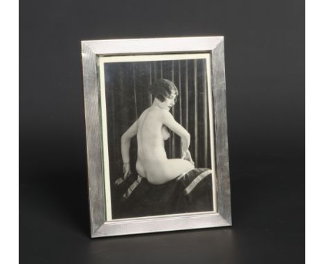 A Continental Art Deco period silver eizel photograph frame. With engine turned angraving and with a monochrome photograph of