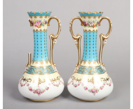 A pair of Copeland Spode twin handled mantel vases. Turquoise ground, with raised gilding and painted with flowers. Printed m