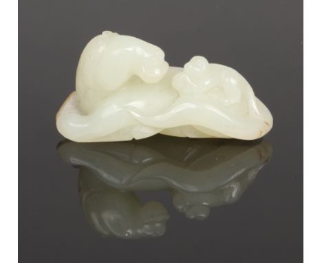 A late 19th century Chinese pale celadon jade carving. Formed as a recumbent horse with a monkey on its back, with dark suffu