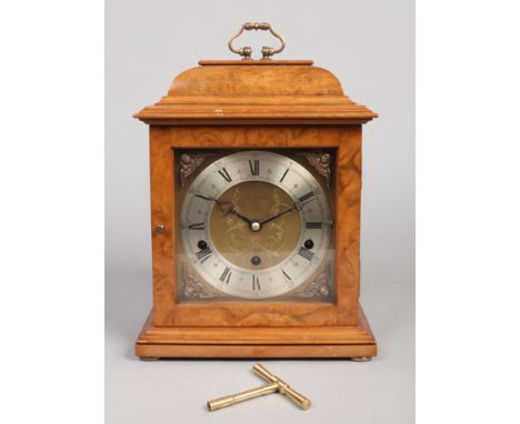 An Elliot burr walnut table clock. With square brass dial signed R. A. Braithwaite, York, having silvered chapter ring and or