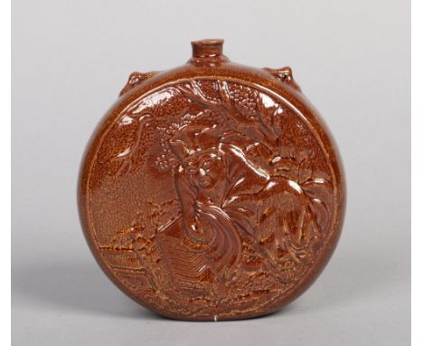 A Linthorpe pottery moon flask designed by Dr. Christopher Dresser. Treacle glazed and moulded with an Oriental gentleman to 