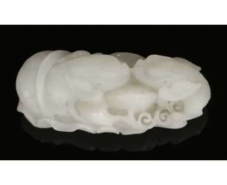 A 19th century Chinese pale celadon jade carving. Formed as a pair of mythical reptile beasts clambering over leaves, 9cm wid