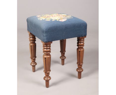 A Victorian carved mahogany stool with needlework upholstery, 47cm high. 