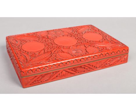 A Chinese cinnabar lacquer rectangular box and cover. Decorated in relief with peonies and ears of corn over a scroll ground 