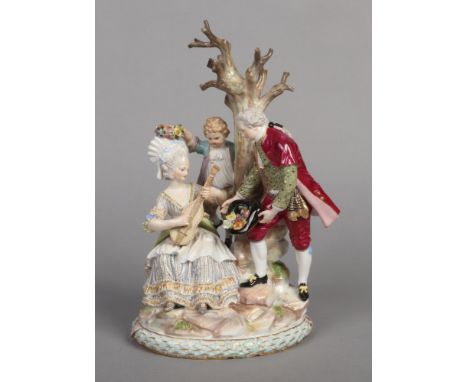 A 19th century Meissen figure group decorated in coloured enamels. Formed as a lady, gent and child gathered around a tree on
