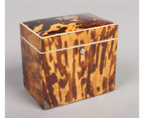 A Victorian tortoiseshell tea caddy with ivory stringing and a single lidded compartment, 11cm wide. Some loss to the stringi