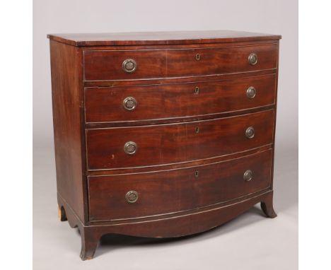 A Regency mahogany bow front chest of four graduated drawers. Crossbanded, with bronze loop handles and raised on splay brack