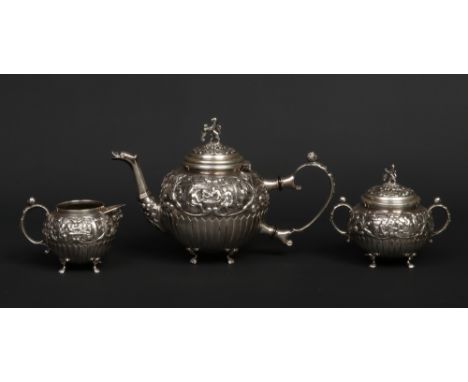 A 19th century Dutch silver three part bachelors teaset. With caryatid handles and with repousse decoration showing tavern sc