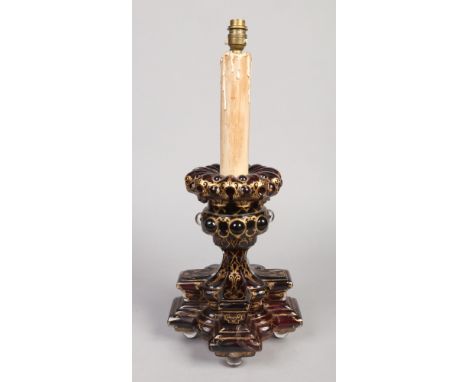 An early 20th century Bohemian cranberry glass table lamp base.  In Gothic revival style and with gilt decoration. Glass only