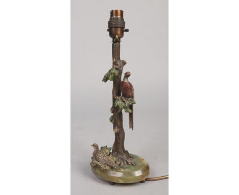 A cold painted bronze and onyx tablelamp base. Surmounted with a cock and hen pheasant perched on a tree, 33cm. Wiring not te