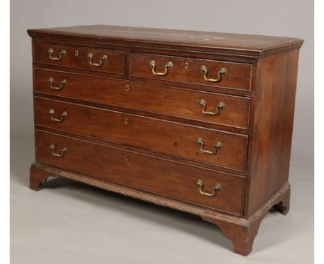 A George III oak chest of drawers of wide proportions. With cock beading, bronze handles and raised on bracket feet, 128cm wi