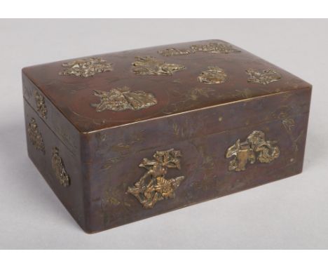 A Japanese Meiji period bronze overlay rectangular box with hinged cover. Decorated with applied leaves, fruit and flowers on