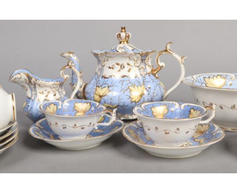 A Rockingham Neo-Rococo part tea and coffee set. Moulded with C-scroll borders, three spur handles and ground in periwinkle b