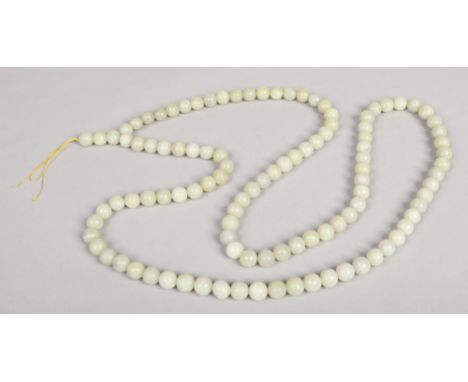 A long string of celadon jade beads, 186cm. 