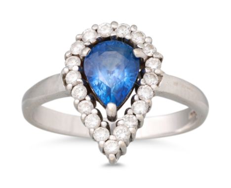 A SAPPHIRE AND DIAMOND CLUSTER RING, the central pear shaped sapphire to a diamond surround, mounted in 18ct white gold, size