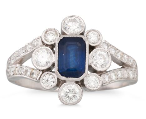 A DIAMOND AND SAPPHIRE CLUSTER RING, the octagonal sapphire to a diamond surround &amp; shoulders, mounted in 18ct white gold