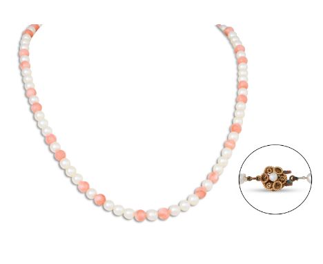 A MIKIMOTO CULTURED PEARL AND CORAL NECKLACE, the cream tone pears to coral spacers, to a 9ct gold clasp, box, and original p