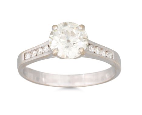 A DIAMOND SOLITAIRE RING, the old cut European stone to diamond shoulders, mounted in 18ct white gold. Estimated: weight of d