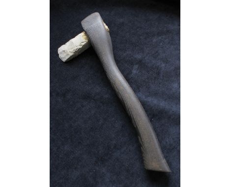 Modern reproduction of a Neolithic hand axe with ash handle and greenstone axehead.